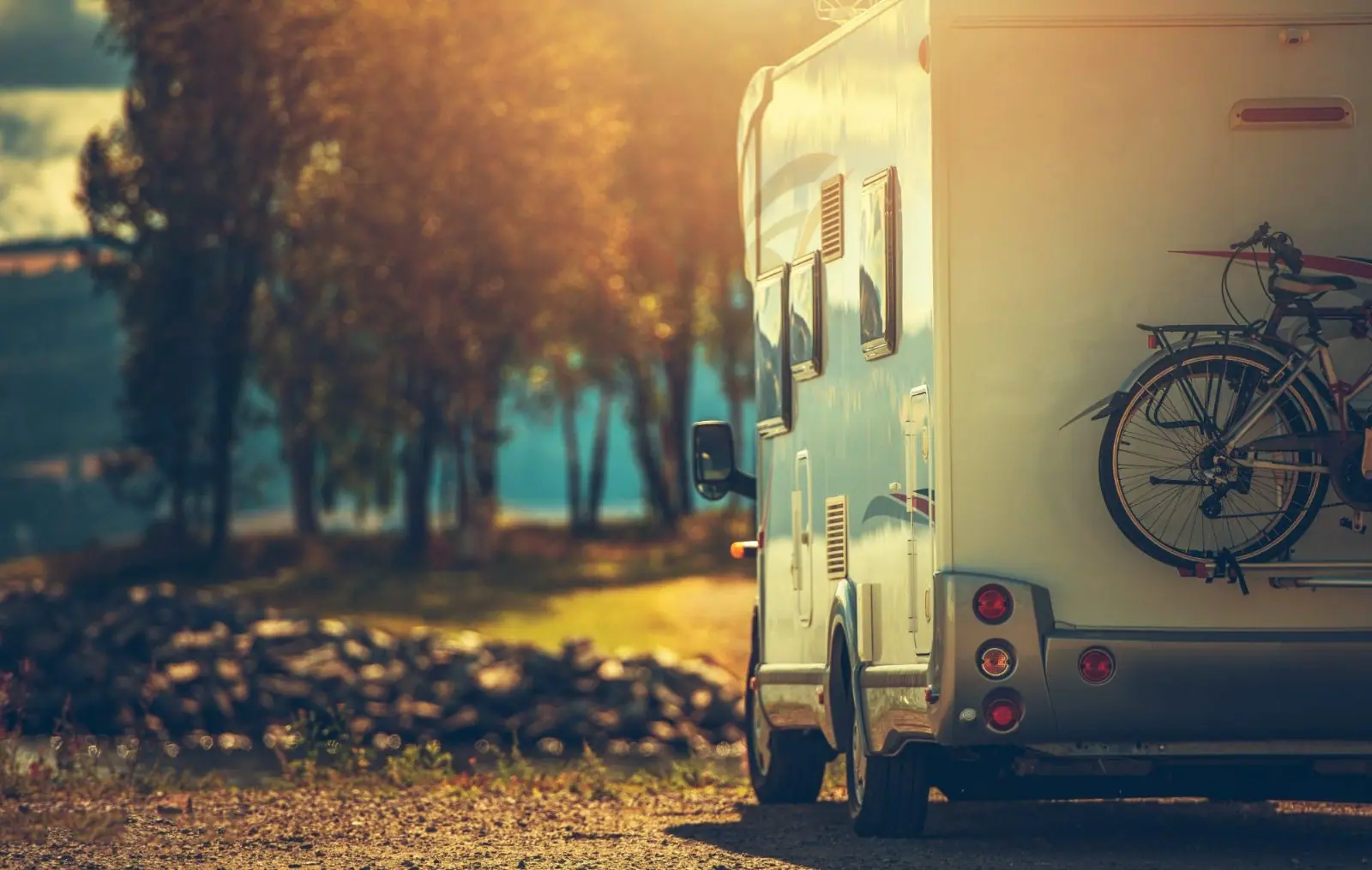 Motorhome by a lake in golden light